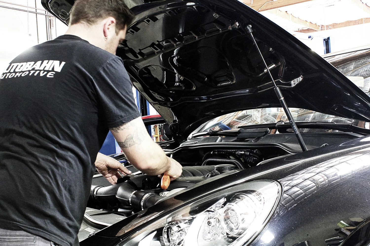 Autobahn Automotive owner Zach installing brake calipers